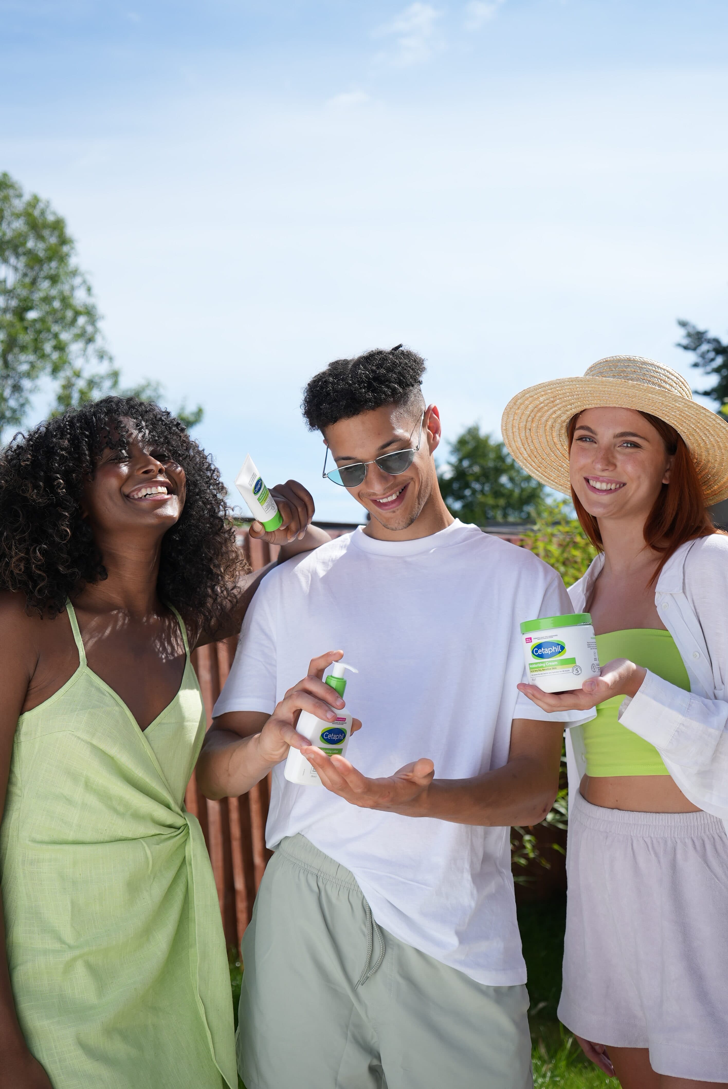 Group of people holding Cetaphil products